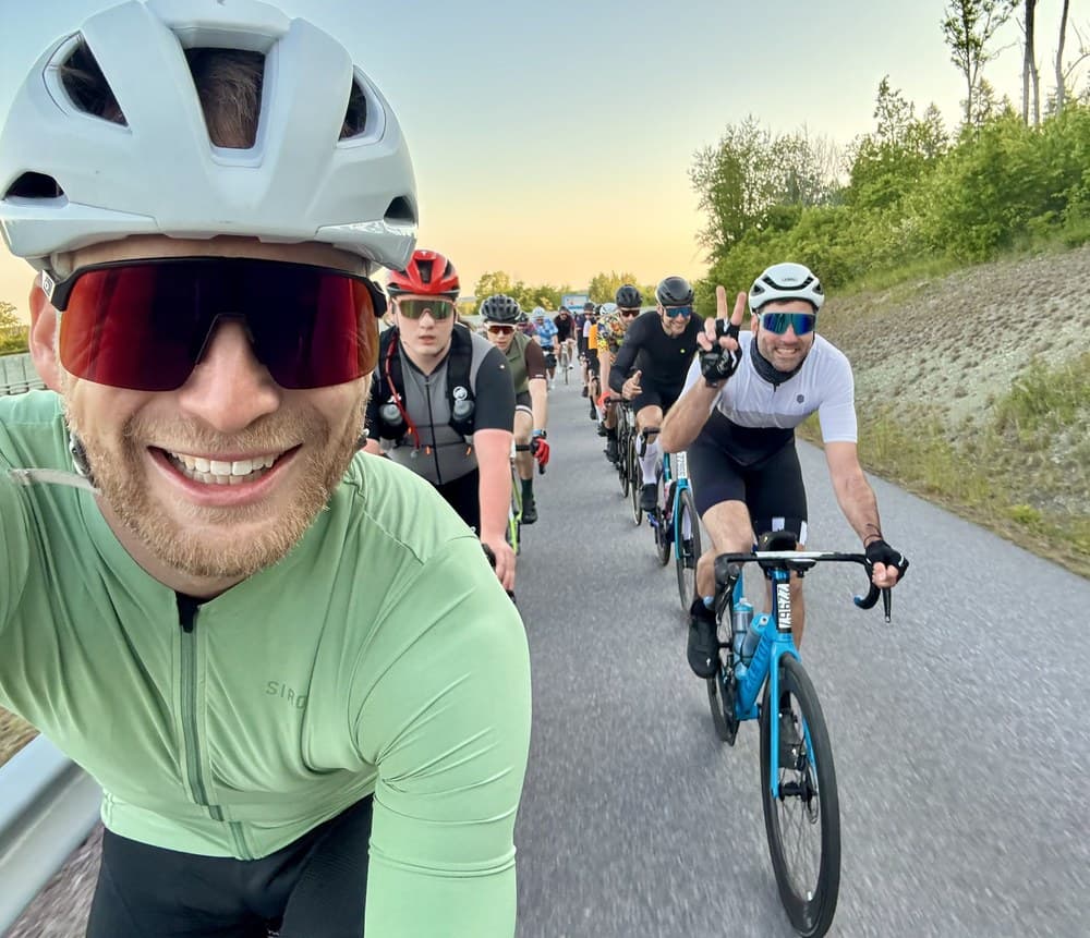 Sven in einer Gruppe von Rennradfahrern im Morgenlicht